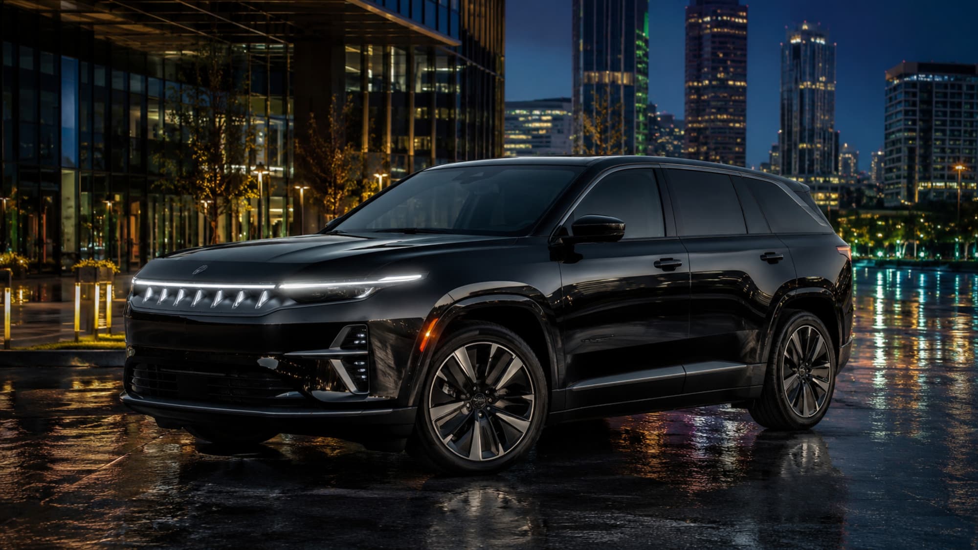 A black 2025 Jeep Wagoneer S at a lit office plaza after rain